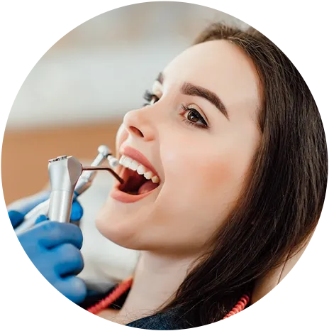 Female patient receiving professional dental cleaning during routine exam at San Antonio dentist office Female patient receiving professional dental cleaning during routine exam at San Antonio dentist office