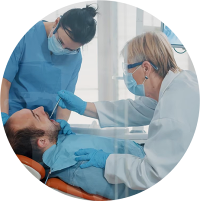 Man undergoing oral cancer screening by dentist at Dominion Smiles in San Antonio, TX